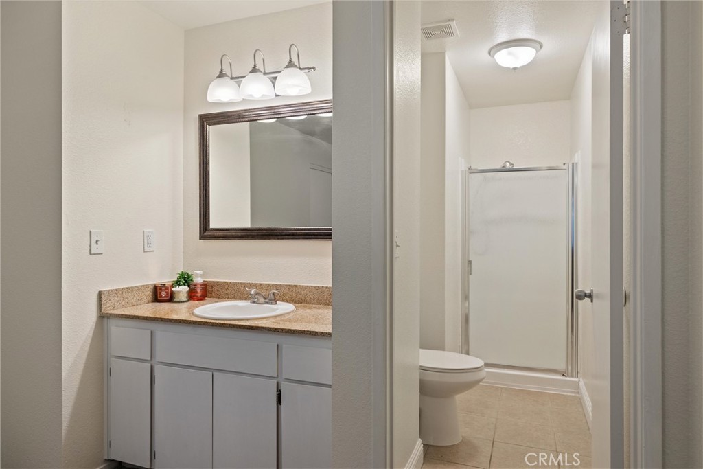 2055 Amanda Way, Unit 29 Chico, CA 95928 - Photo 17 of 19 a bathroom with a toilet sink and mirror