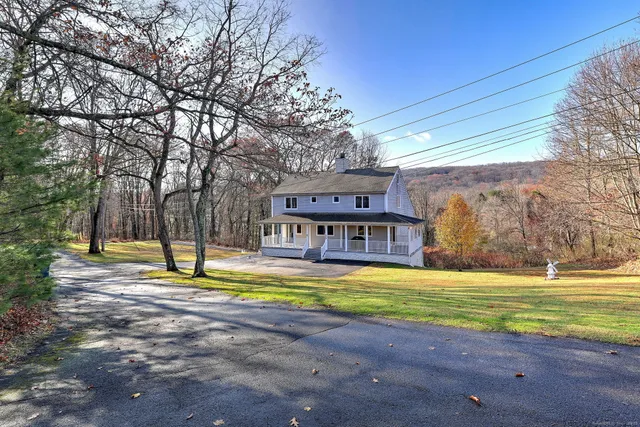 a view of a house with swimming pool and sitting area