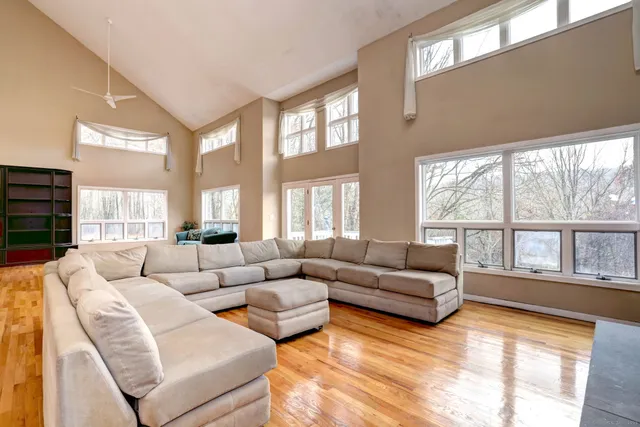 a living room with furniture and a wooden floor