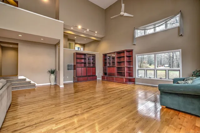 a view of a living room with furniture and kitchen view
