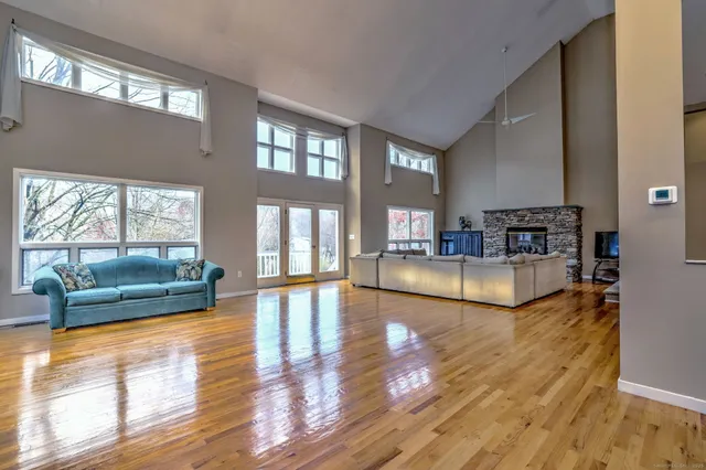 a kitchen with granite countertop white cabinets white appliances a sink and a window