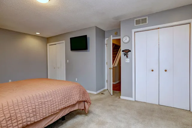 a bathroom with a toilet sink vanity and shower