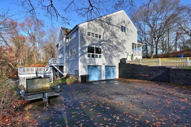 a view of an house with backyard and a tree
