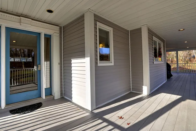 a view of a hallway with wooden floor and closet