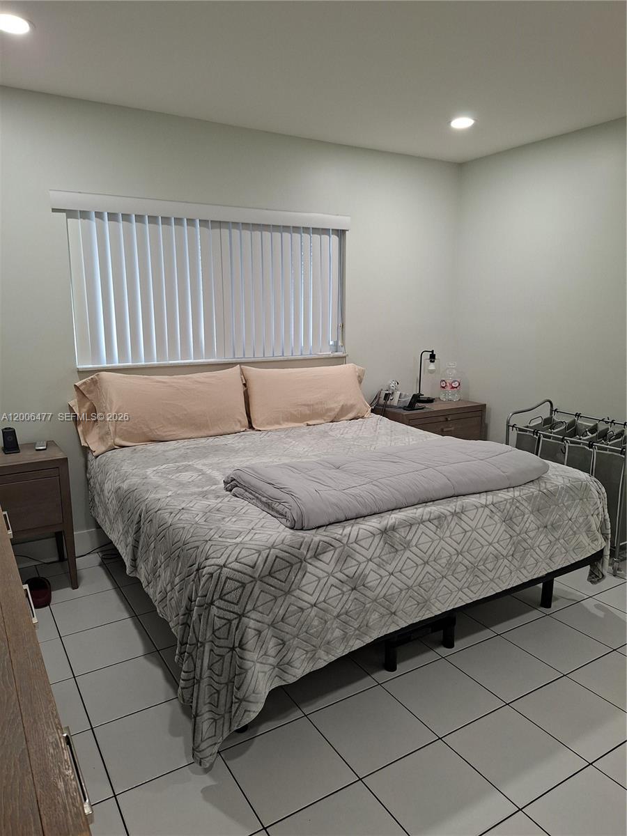1814 Southwest 97th Terrace, Unit A Miramar, FL 33025 - Photo 7 of 9 a bedroom with a bed and a window