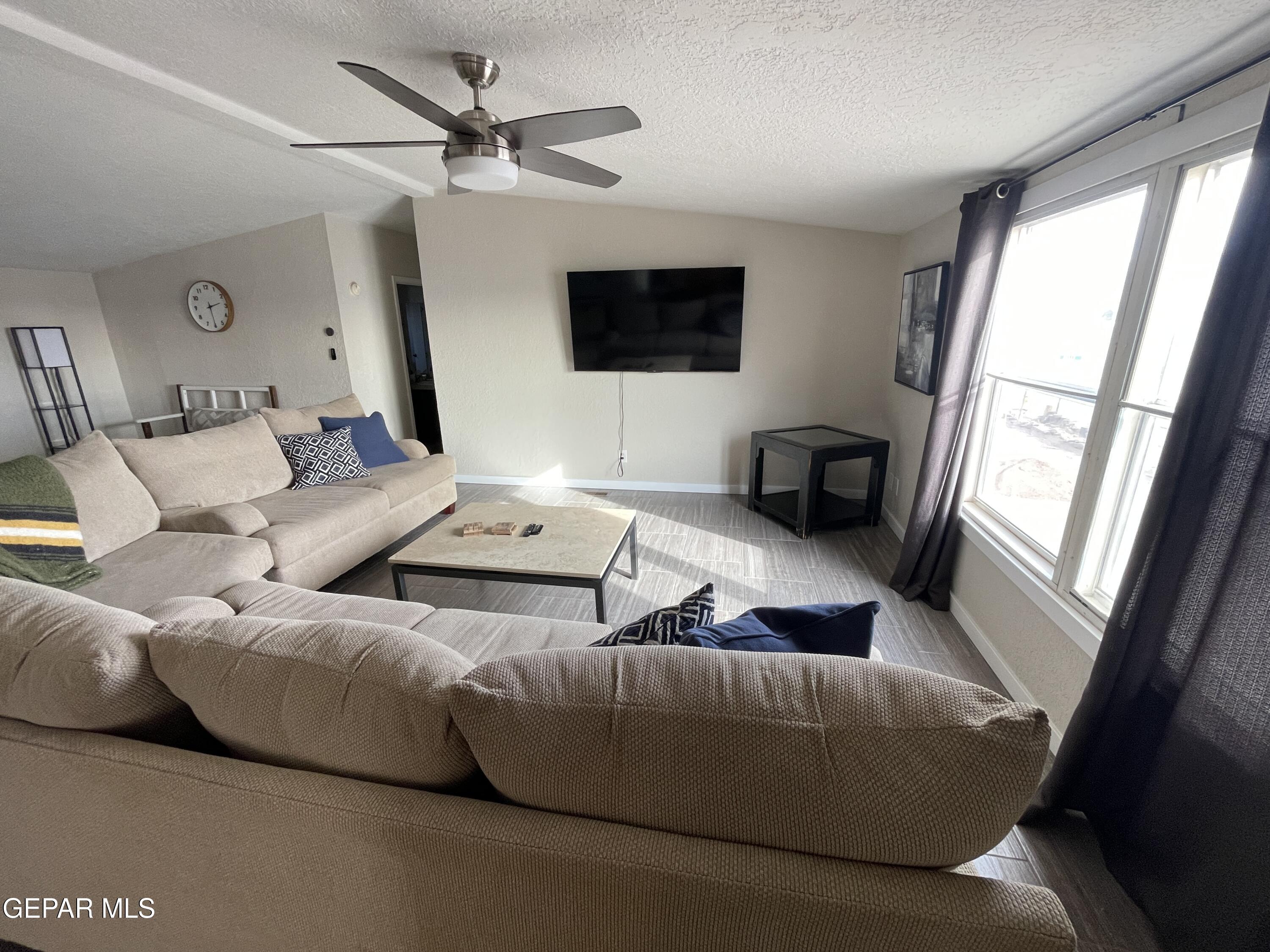2901 Cook Street Truth Or Consequences, NM 87901 - Photo 5 of 28 a living room with furniture a flat screen tv and a large window