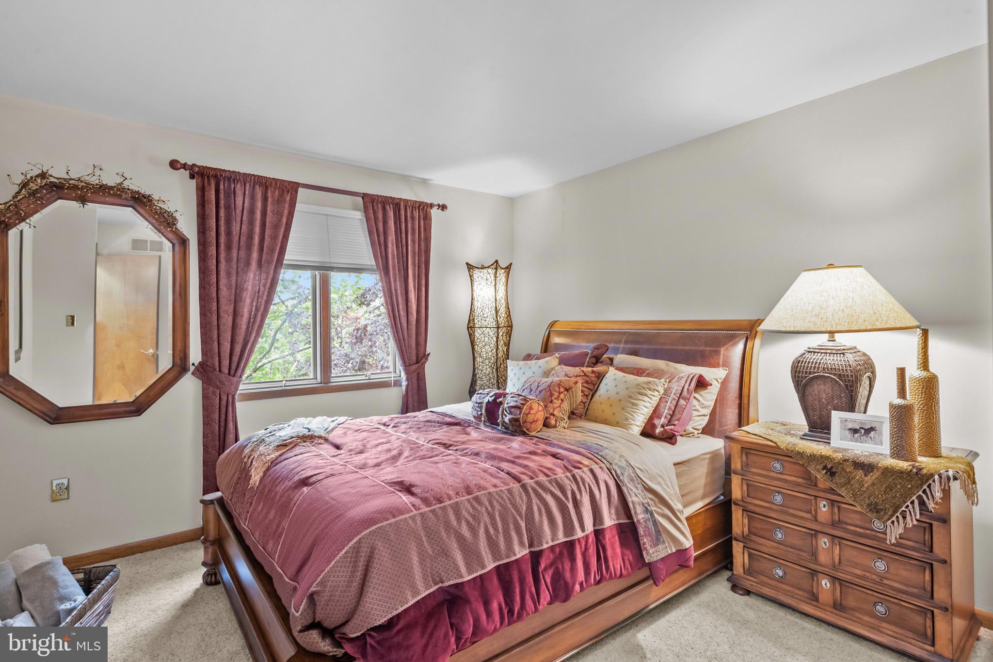 16 Golfview Lane Reading, PA 19606 - Photo 47 of 70 a bedroom with a bed a mirror on dresser and a window