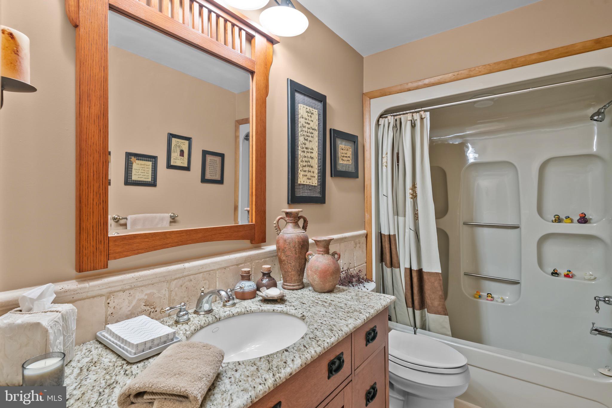 16 Golfview Lane Reading, PA 19606 - Photo 48 of 70 a bathroom with a granite countertop sink vanity mirror bathtub and toilet