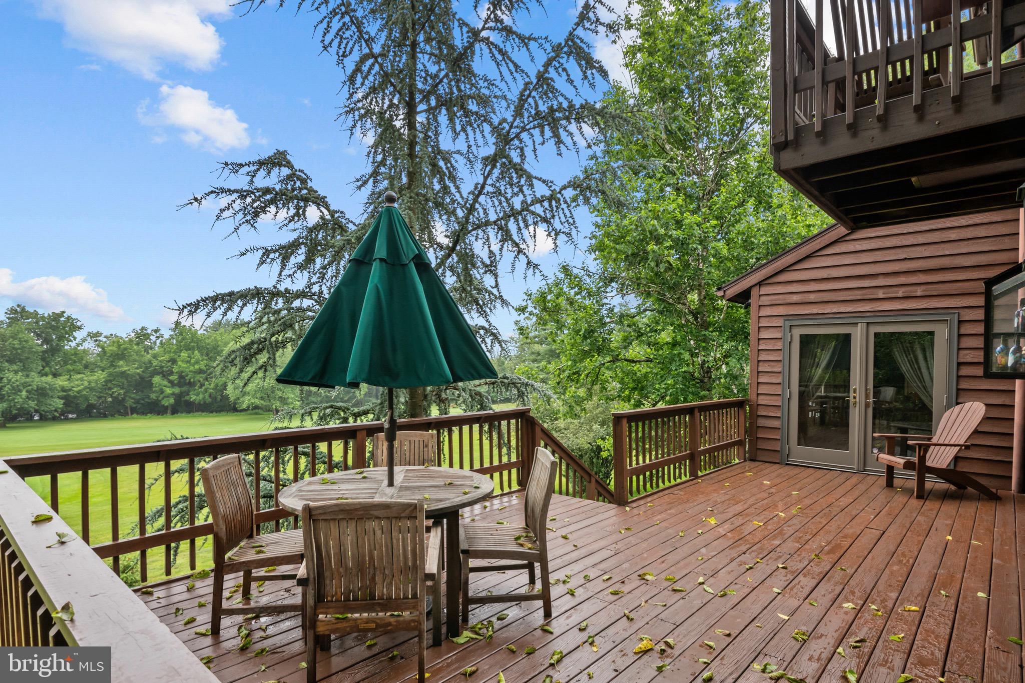 16 Golfview Lane Reading, PA 19606 - Photo 59 of 70 a view of a roof deck with table and chairs a barbeque with wooden floor and fence