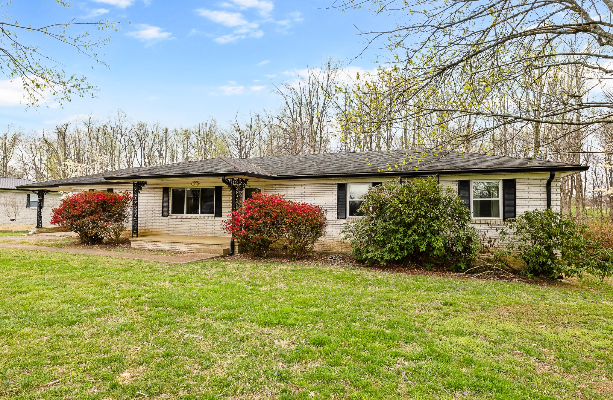 111 Cothron Drive Lafayette, TN 37083 - Photo 2 of 33 a view of a house with backyard and garden