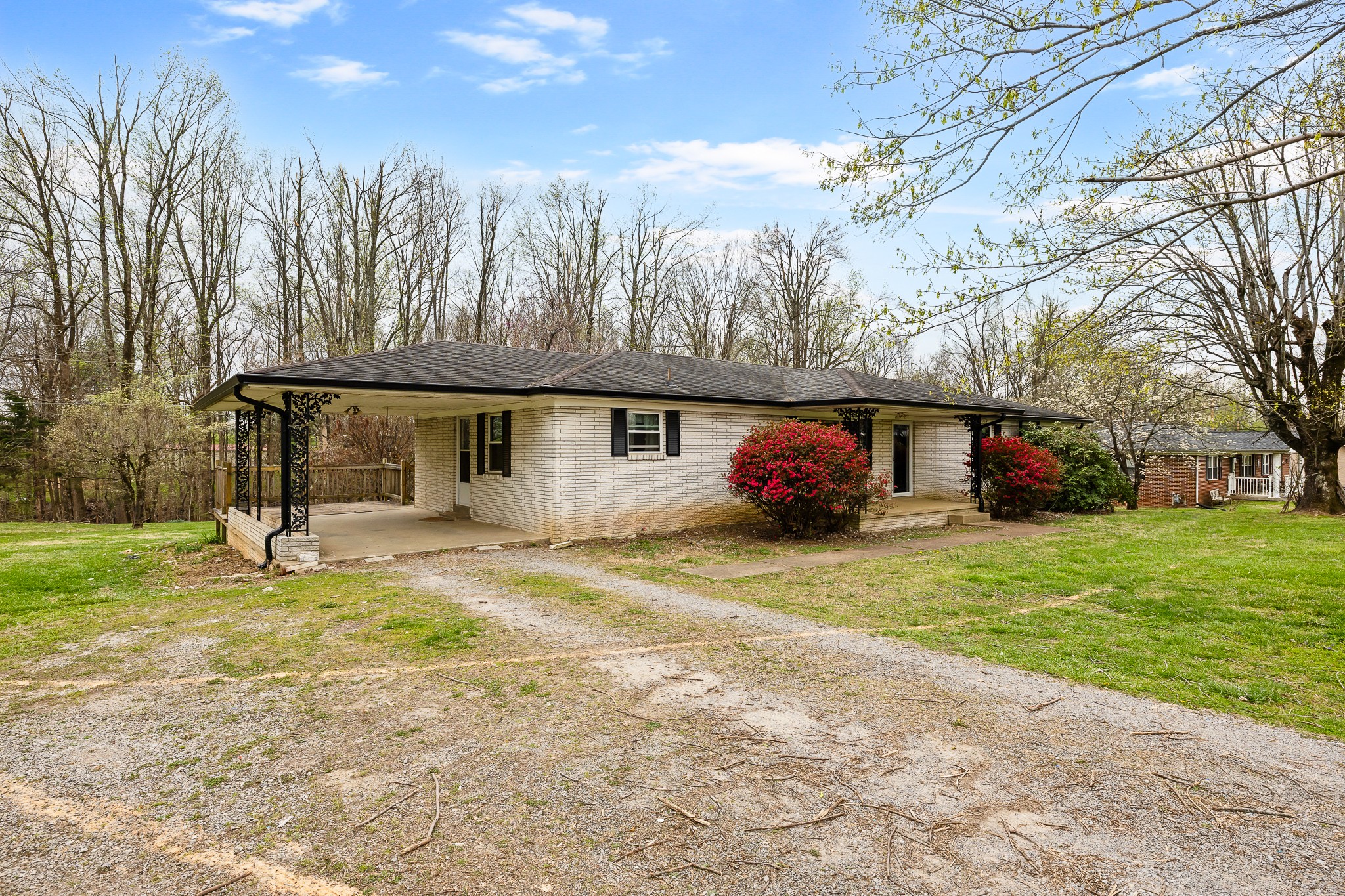 111 Cothron Drive Lafayette, TN 37083 - Photo 3 of 33 a front view of a house with a yard and trees