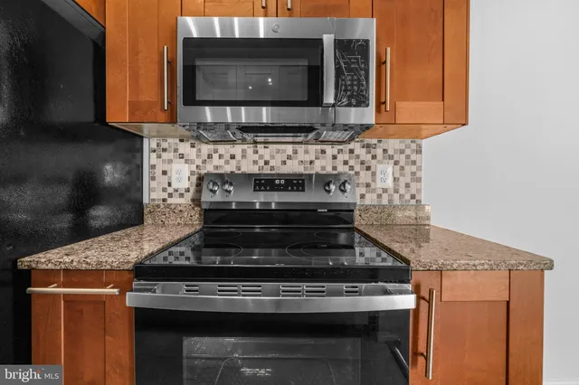 a stove top oven sitting inside of a kitchen