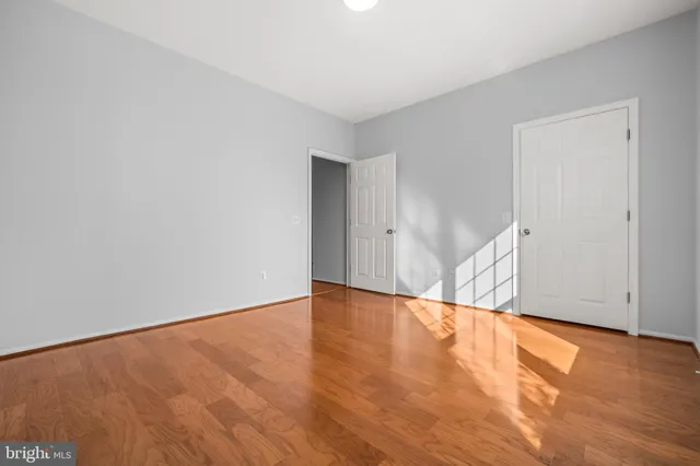 a view of an empty room and wooden floor