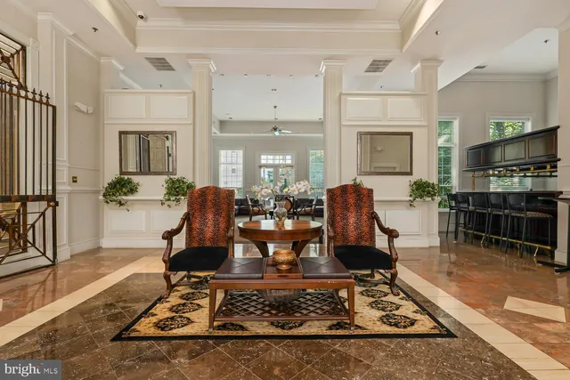 a living room with fireplace furniture and a rug