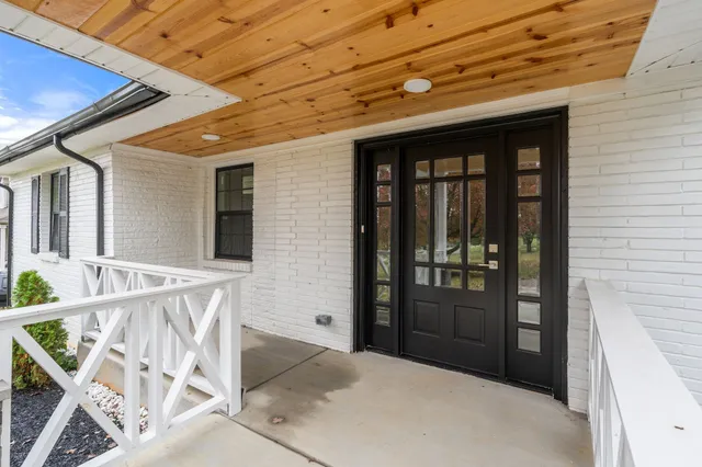 a bathroom with a granite countertop sink a toilet and a mirror