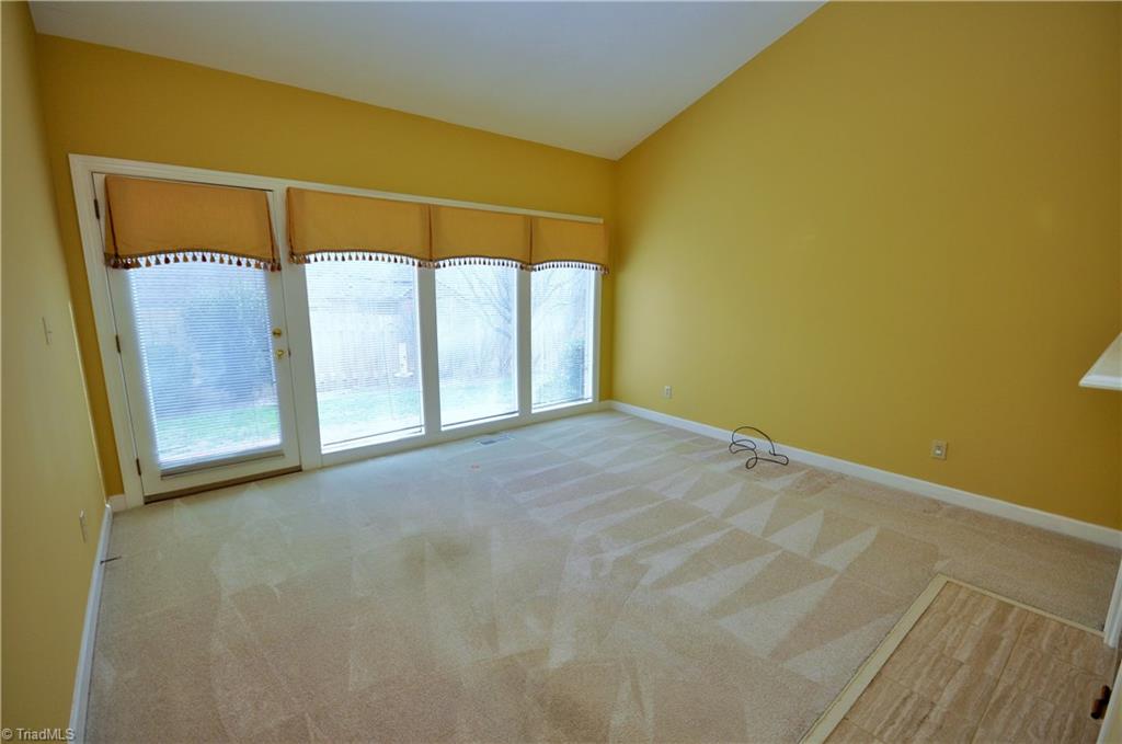 1718 Chickadee Point High Point, NC 27262 - Photo 17 of 30 Den with Vaulted ceiling and fireplace, lots of windows and light.