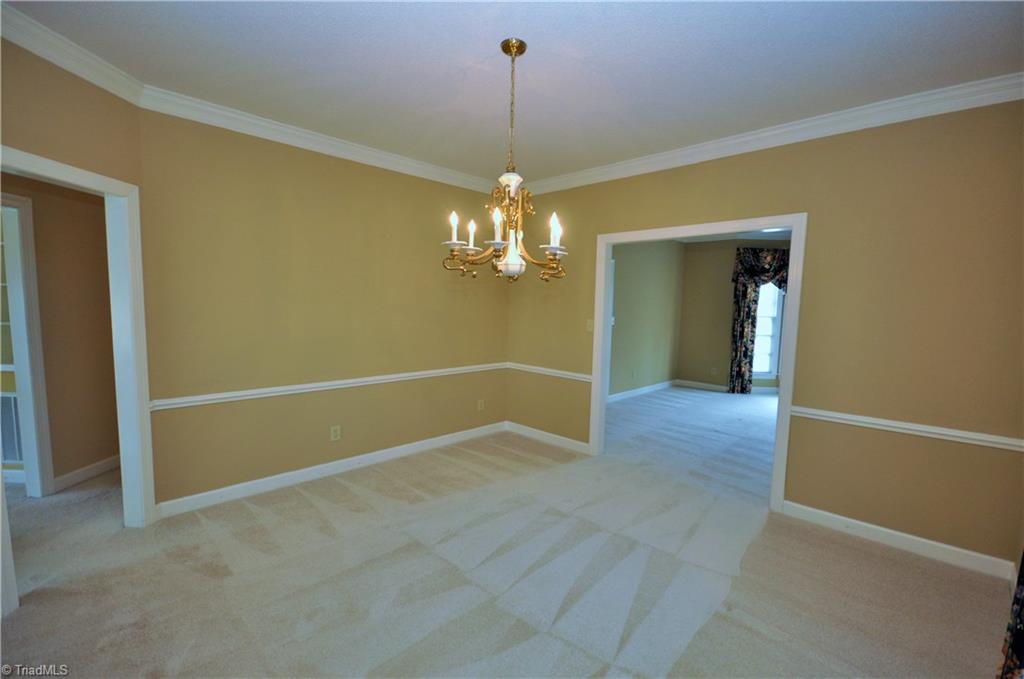 1718 Chickadee Point High Point, NC 27262 - Photo 10 of 30 Dining room with chair rail and crown molding