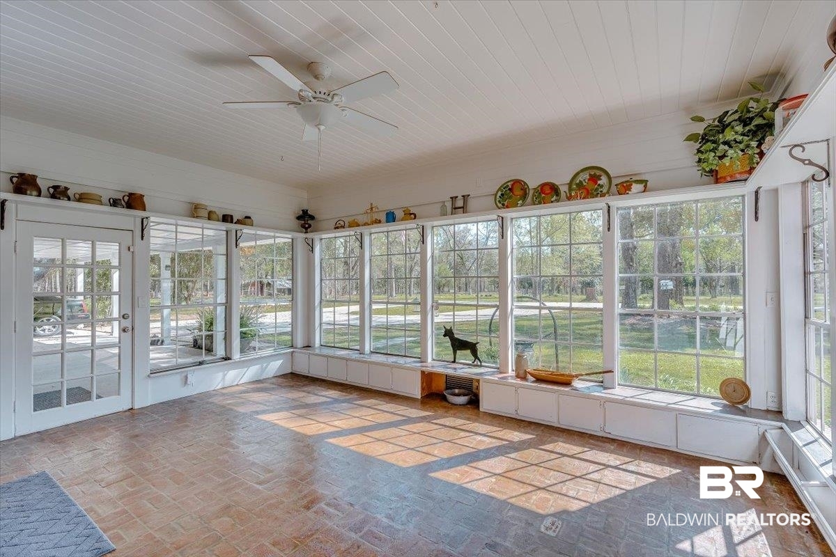 14160 Moffett Road Wilmer, AL 36587 - Photo 9 of 75 Unfurnished sunroom with brick floor and wooden ceiling