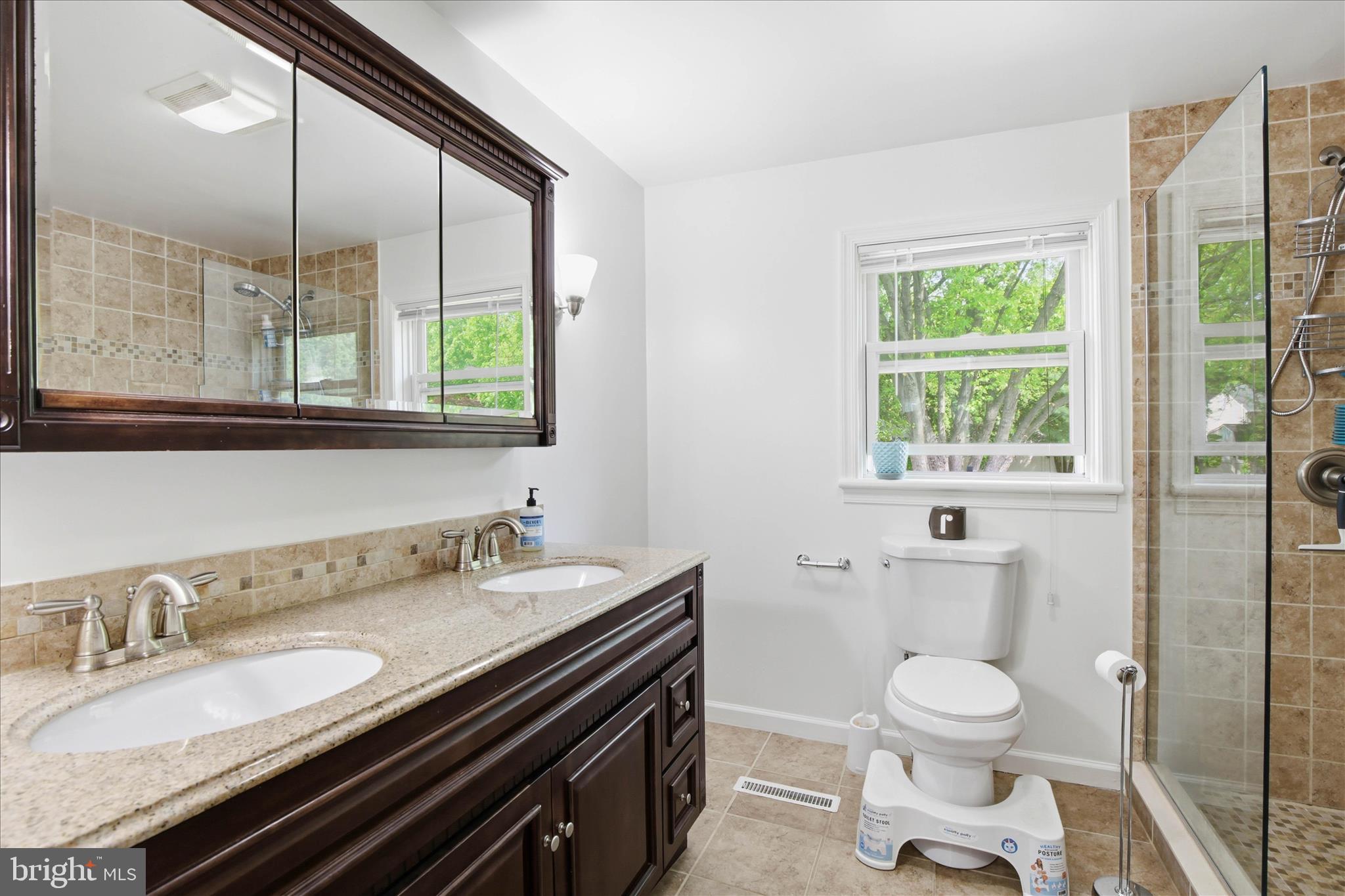237 Delp Road Lancaster, PA 17601 - Photo 24 of 47 a bathroom with a granite countertop toilet a sink a mirror and a window