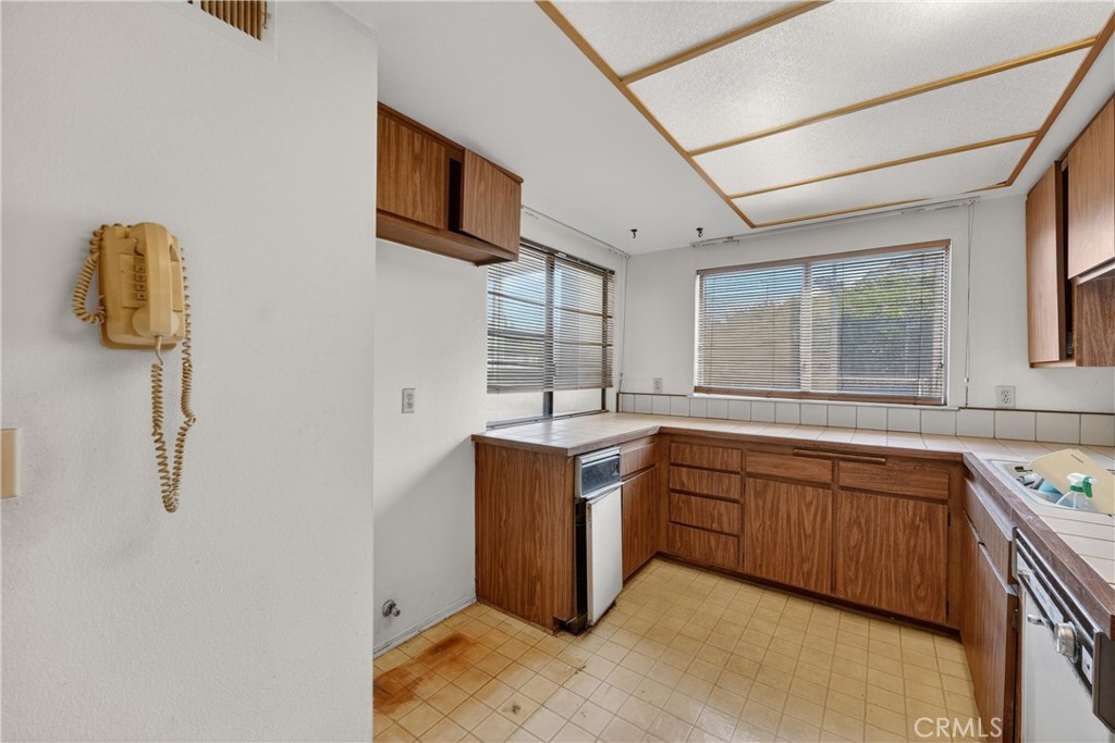 28307 Ridgehaven Court, Unit 72 Rancho Palos Verdes, CA 90275 - Photo 24 of 60 a kitchen with stainless steel appliances granite countertop a sink and dishwasher with wooden floor