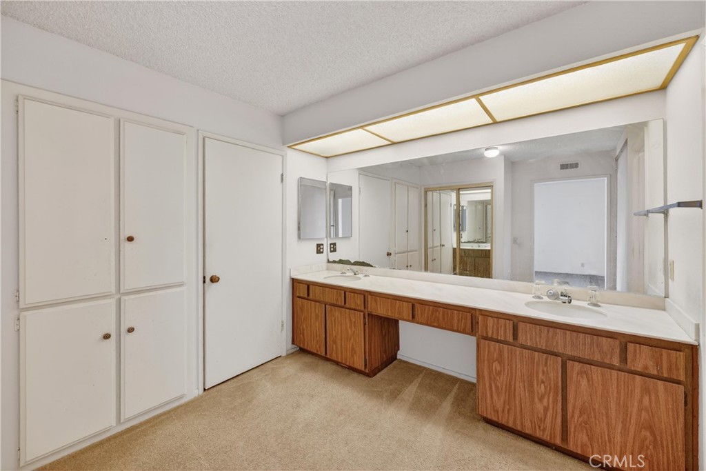 28307 Ridgehaven Court, Unit 72 Rancho Palos Verdes, CA 90275 - Photo 39 of 60 a spacious bathroom with a double vanity sink and mirror