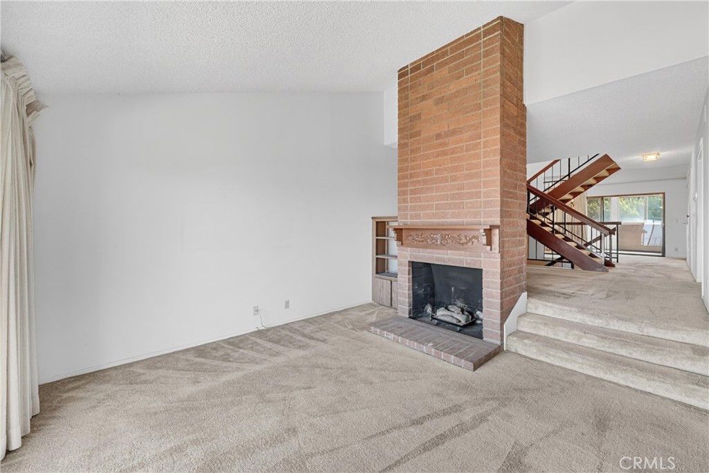 28307 Ridgehaven Court, Unit 72 Rancho Palos Verdes, CA 90275 - Photo 9 of 60 a view of a livingroom with a fireplace and couch