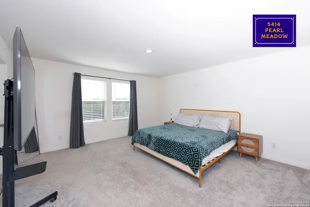 a bed sitting in a room next to a window