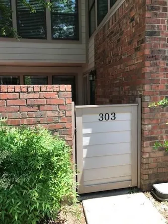 a view of empty room with wooden floor and fireplace