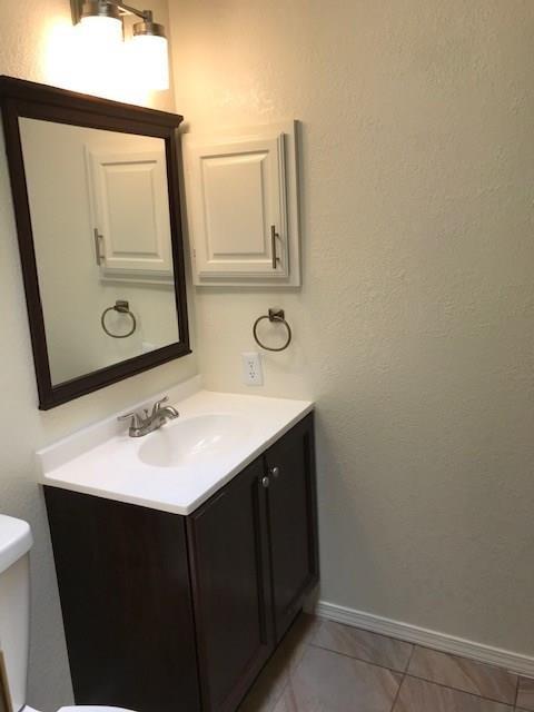 18240 Midway Road, Unit 303 Dallas, TX 75287 - Photo 18 of 22 a bathroom with a sink and a mirror