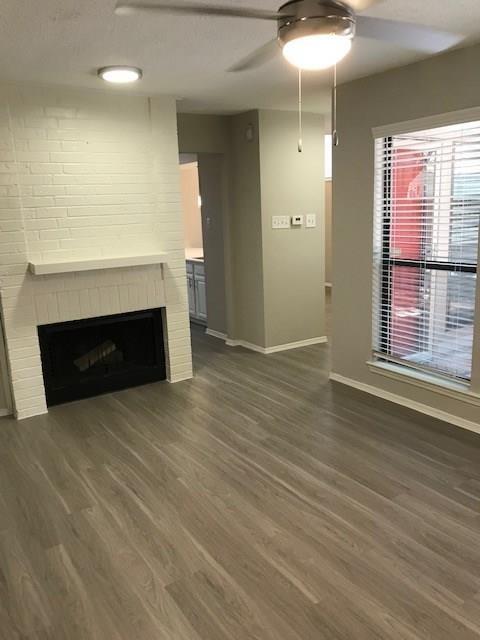 18240 Midway Road, Unit 303 Dallas, TX 75287 - Photo 2 of 22 a view of empty room with wooden floor and fireplace