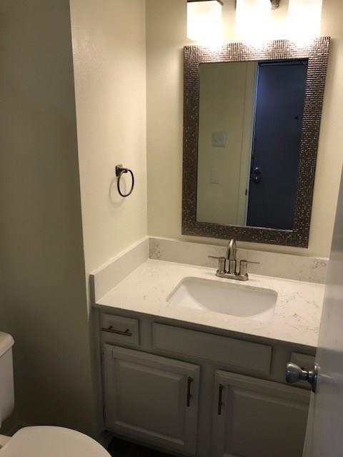 18240 Midway Road, Unit 303 Dallas, TX 75287 - Photo 7 of 22 a bathroom with a granite countertop sink and a mirror