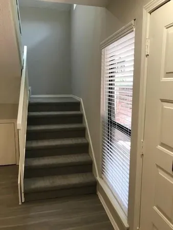a view of staircase with lots of frames on wall