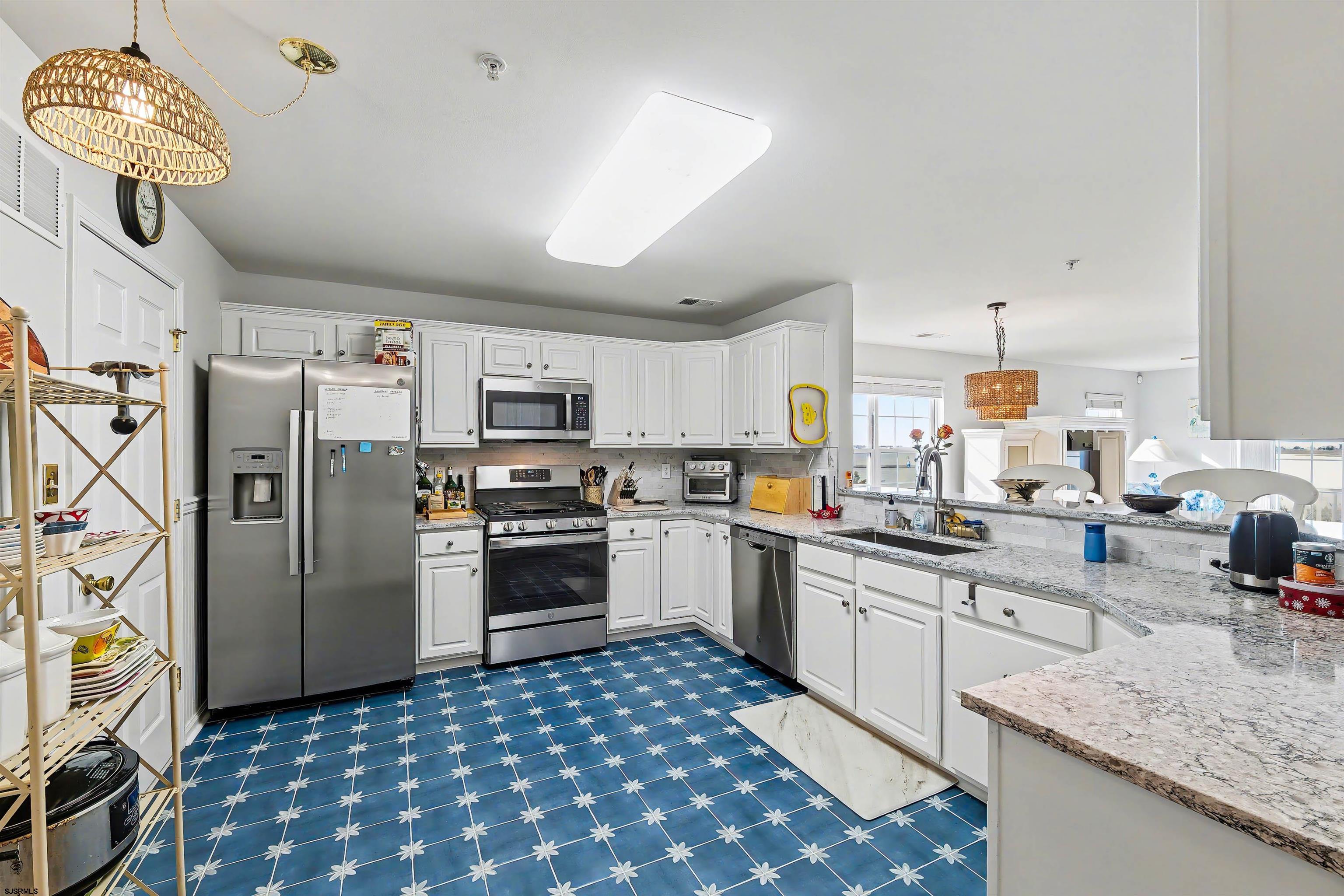 35 Bayside Drive, Unit 35 Somers Point, NJ 08244 - Photo 12 of 40 a kitchen with stainless steel appliances granite countertop a sink a stove and refrigerator
