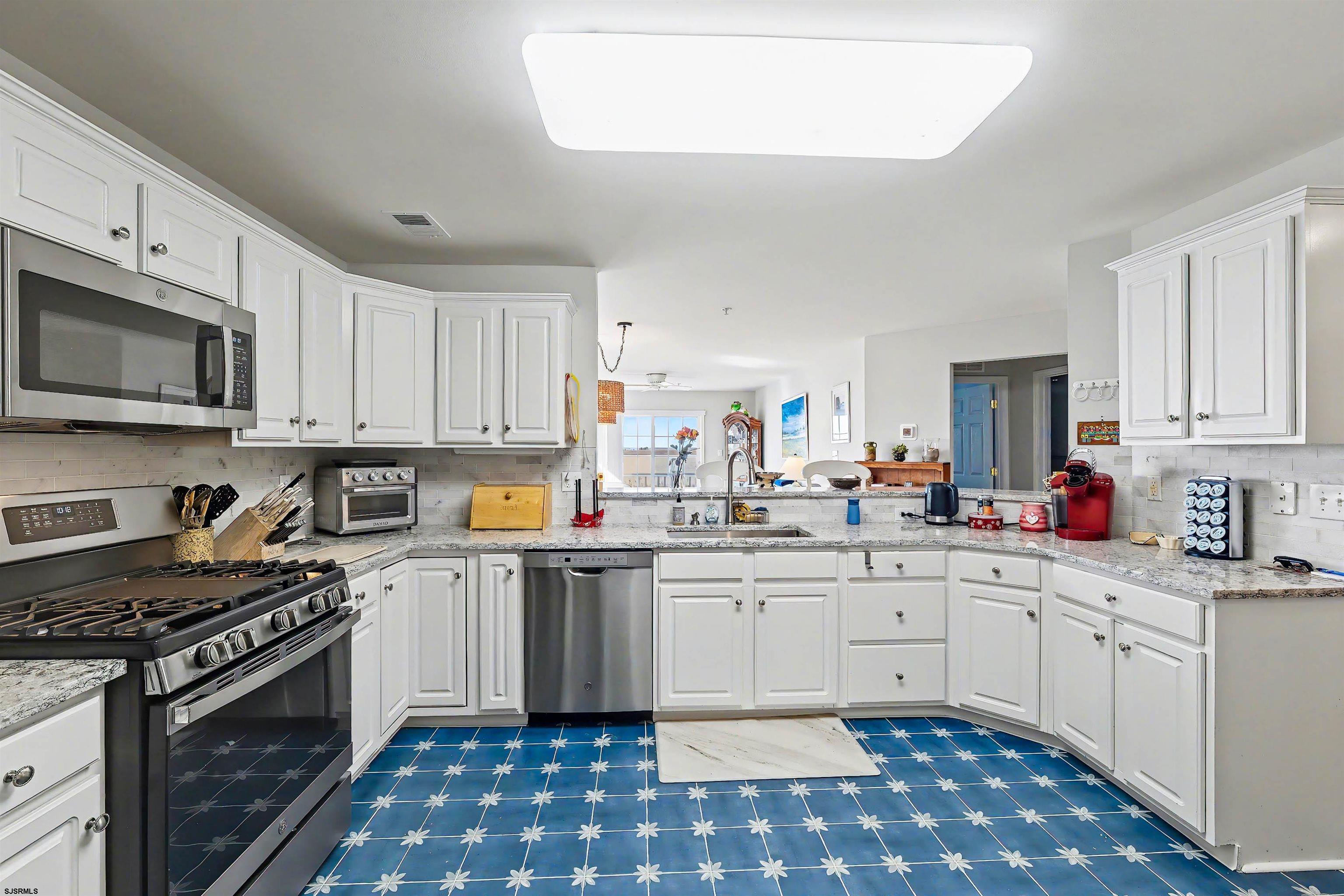 35 Bayside Drive, Unit 35 Somers Point, NJ 08244 - Photo 13 of 40 a kitchen with a sink stove top oven and cabinets