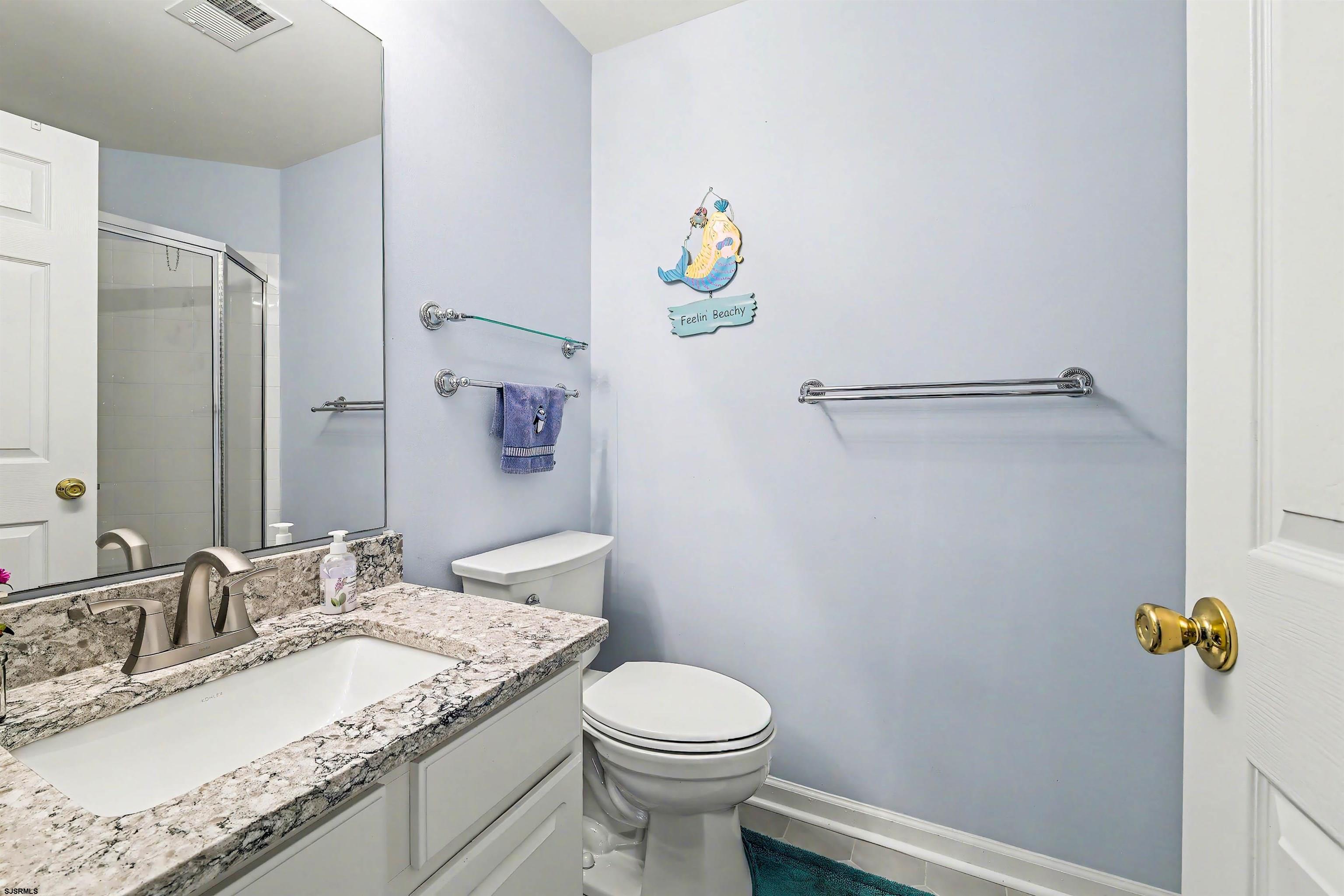 35 Bayside Drive, Unit 35 Somers Point, NJ 08244 - Photo 18 of 40 a bathroom with a granite countertop sink a toilet and a mirror