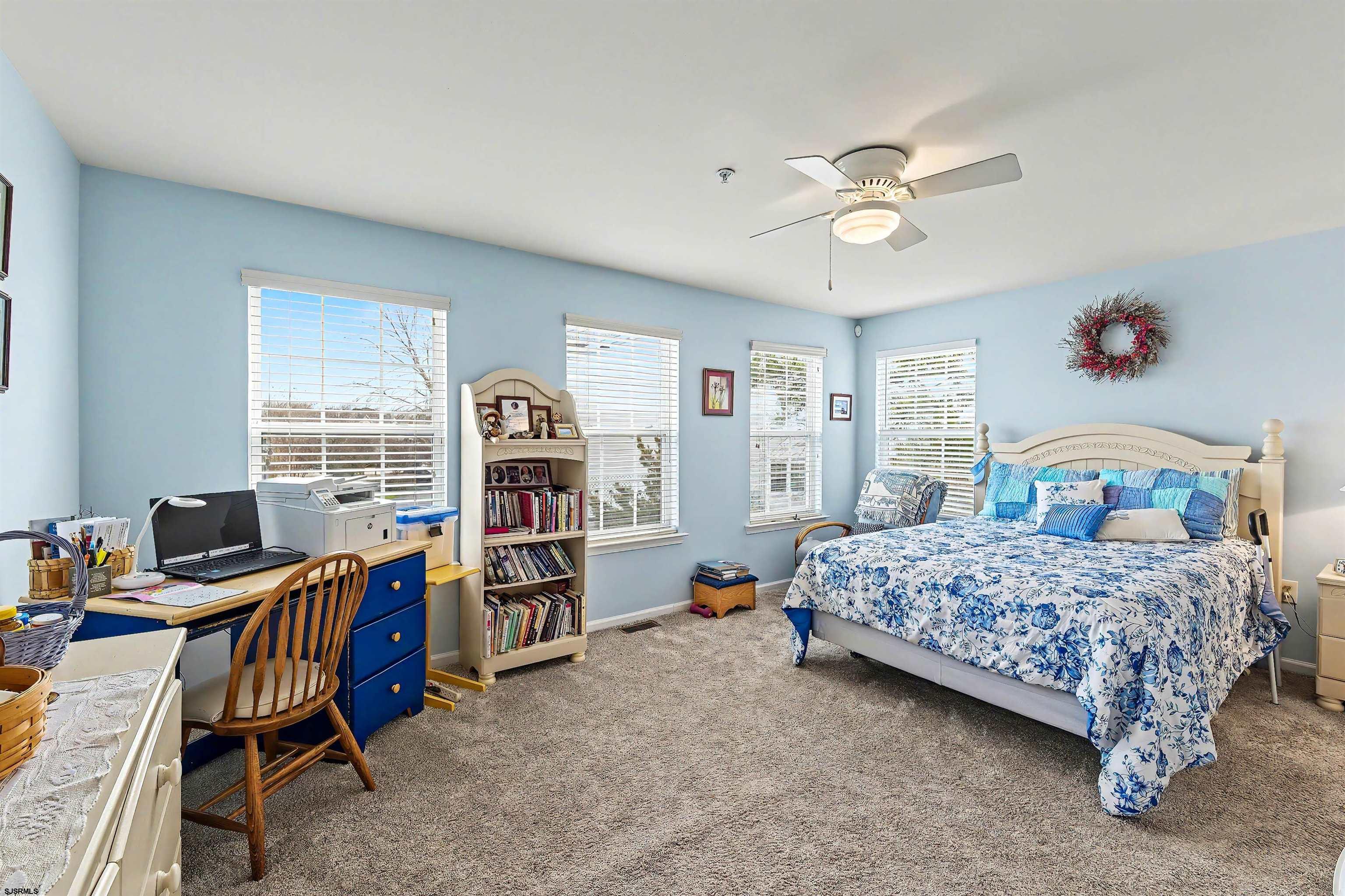 35 Bayside Drive, Unit 35 Somers Point, NJ 08244 - Photo 20 of 40 a bedroom with a bed and a chandelier
