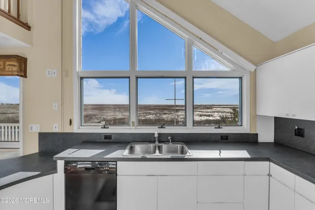 a kitchen with a sink and a stove top oven