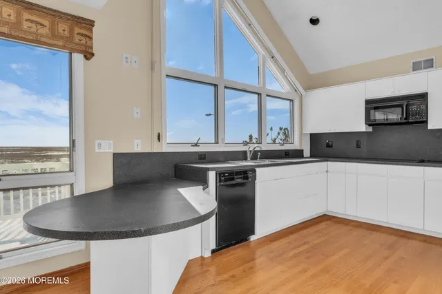 a kitchen with stainless steel appliances a refrigerator and a stove top oven