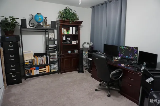 a view of a kitchen with white cabinets