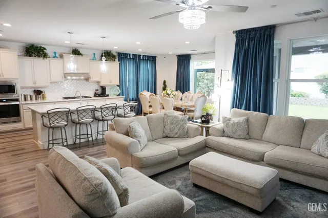 a kitchen with kitchen island wooden cabinets and refrigerator