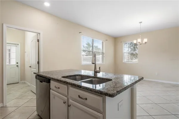 a kitchen with granite countertop a sink and a window