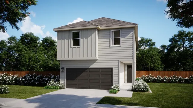 a front view of a house with a garden and plants