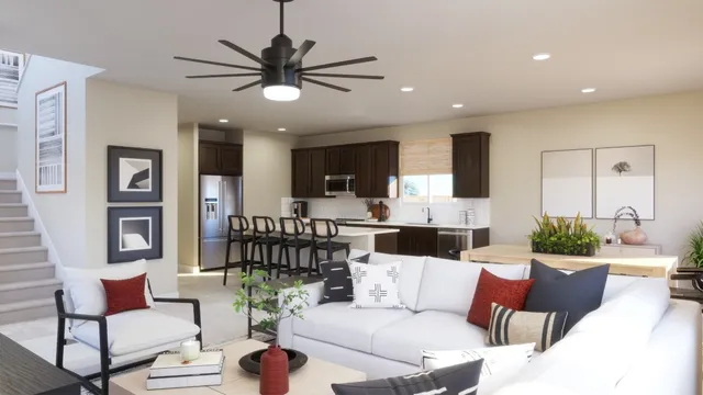 a living room with furniture kitchen view and a chandelier
