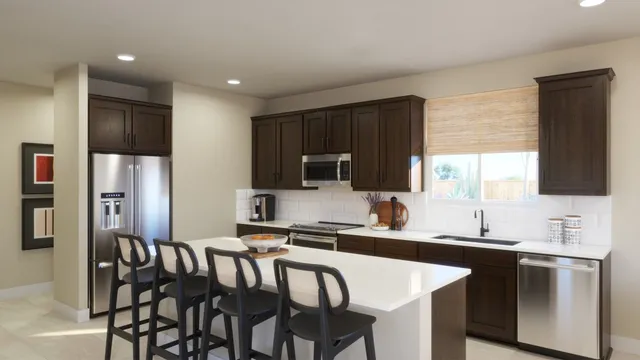 a kitchen with stainless steel appliances granite countertop a sink a stove a refrigerator with a dining table and chairs