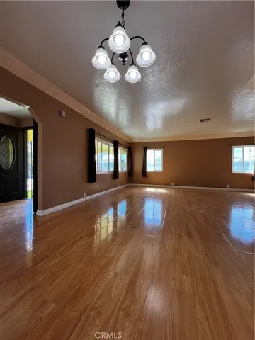 a view of a room with wooden floor
