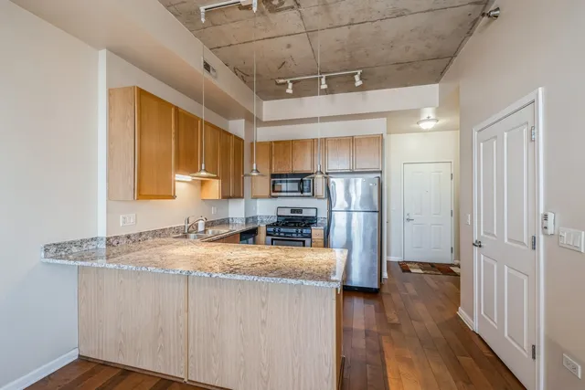 a kitchen with refrigerator cabinets and wooden floor