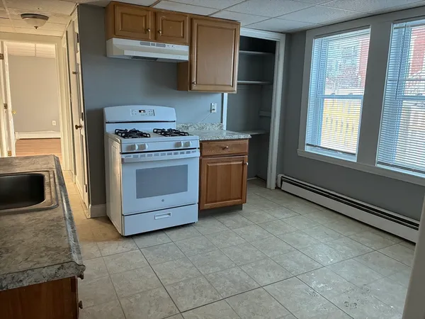a kitchen with a stove top oven and cabinets