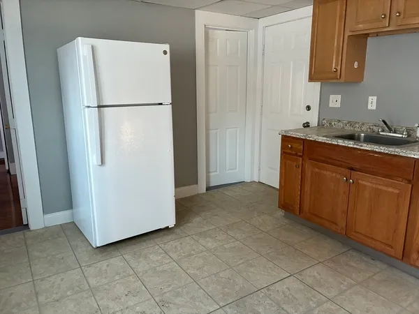 a white refrigerator freezer sitting in a kitchen