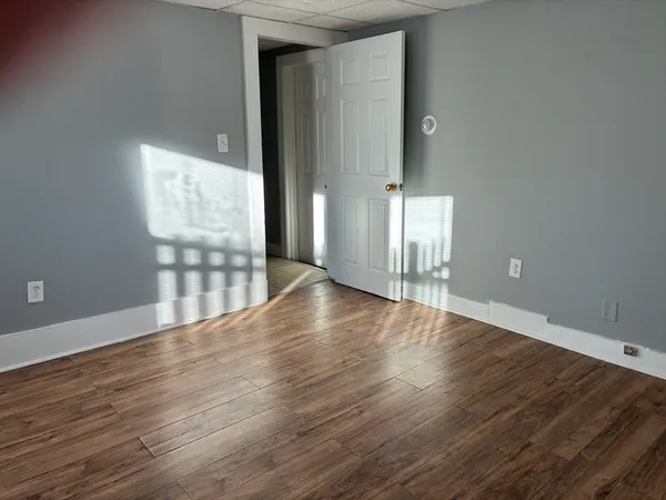 a view of wooden floor and windows in an empty room
