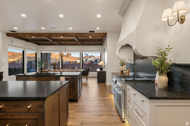 4871 South Homestead Way Washington, UT 84780 - Photo 24 of 151 Kitchen featuring high end stainless steel range oven, beam ceiling, light wood finished floors, decorative backsplash, and dark stone countertops